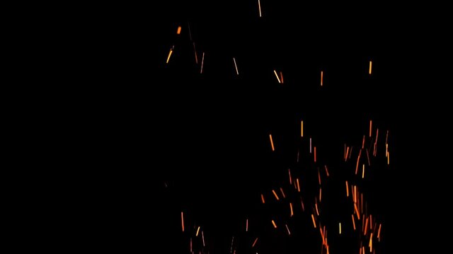 Beautiful colorful sparks of bonfire flying to the dark night sky