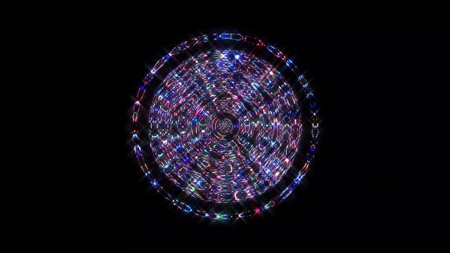 animated round shape of multicolor flashing lights, on a black background