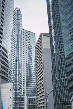 Vertical photograph of Makati city skyscrapers reflecting each other on a cloudy day. Urban photography