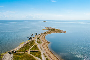 Aerial shot of the Sorve peninsula by the Baltic sea from the Sorve lighthouse in Saaremaa, Estonia. Clear blue sky, calm weather