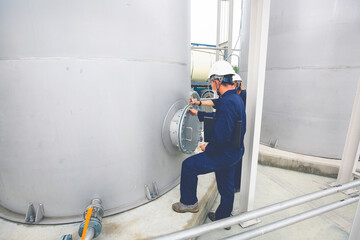 Male worker works permit industry visual inspection stainless tanks