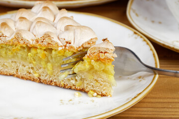 Closeup piece of homemade pie decorated with meringue. Shallow focus.