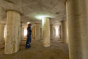 Fototapeta na wymiar Working male inspection pole underground of tank equipment tunnel