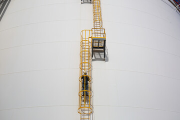 Male climb the stairway ladder storage visual inspection tank