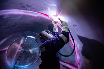 Welding  arc argon worker male repaired metal is welding sparks industrial construction tank...
