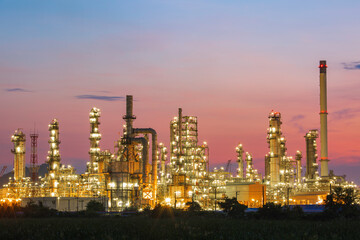 Obraz na płótnie Canvas Oil​ refinery​ and​ plant and tower column of Petrochemistry industry in oil​ and​ gas​ ​industrial with​ cloud​ red sky