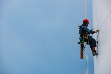 Male workers down height tank rope access inspection of thickness shell plate storage tank gas