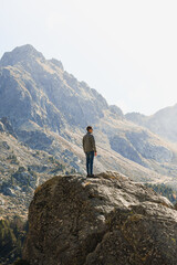 Young hiker on top of a rock enjoying mountain views in Andorra