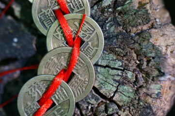 A bunch of Chinese coins that attract good luck and wealth. Hieroglyphs mean attracting good luck and financial well-being.