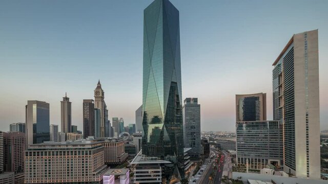 Dubai International Financial district aerial day to night timelapse. Panoramic view of business and financial office towers.
