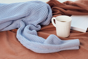 a blanket near the window a cup of coffee book Comfort rest