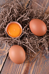 Brown chicken eggs on wooden background