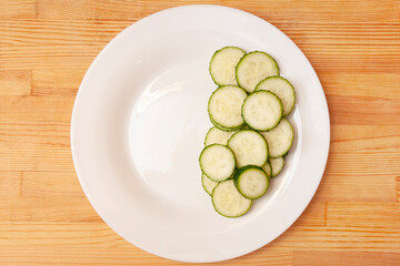 The rate of consumption of vegetables. Half a plate of cucumbers. Green food. Vegetable balance. Diet food
