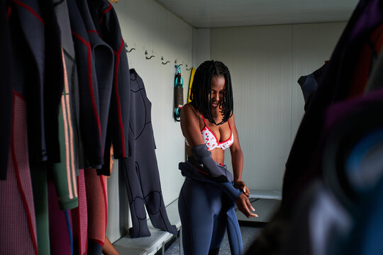 Black Woman Wearing Wetsuit In Dressing Room