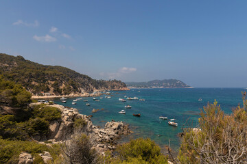 Fototapeta na wymiar bay full of tourist boats on the costa brava on a sunny summer day