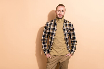 Photo of young wondered guy thoughtful look empty space chief boss isolated over beige color background