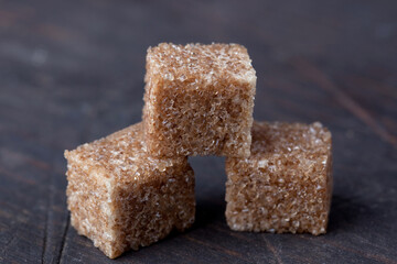 rope sugar in cubes close-up on a wooden background
