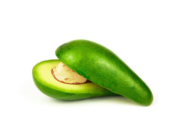 An avocado cut in half and with a bone in one half