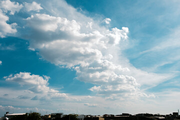clouds in the blue sky over the city and residences