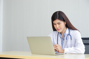 Asian female doctor online video call Check the symptoms with the patient via the Internet. on a laptop computer. The concept is connected to communication through online technology.
