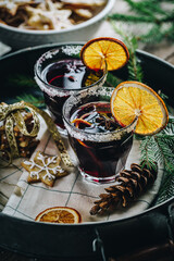 Tray with Swedish glögg in glass and ginger cookies . Traditional Nordic drink. Mulled wine with...