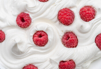 Fresh raspberries in the yoghurt or cream. Top view.