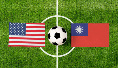 Top view soccer ball with USA vs. Taiwan flags match on green football field.