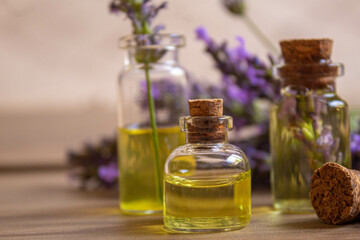 Obraz na płótnie Canvas Lavender essential oil in a small bottle. Selective focus.