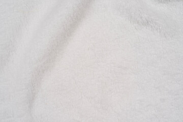 Fototapeta na wymiar White delicate soft background of plush fabric is beautiful warm winter cloth