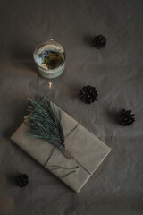 Christmas composition. Gift, fir tree branches, balls on paper background. Christmas, winter, new year concept. Flat lay, top view, copy space