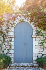 blue wooden door in rustic stone wall