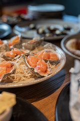 dish tar tar ceviche of salmon in an oyster shell on the table in a restaurant