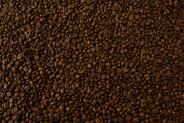 Coffee beans, texture. Background made of natural coffee beans, top view