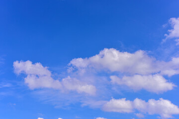 Puffy fluffy white clouds against daytime sky.