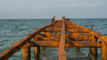 old pier going into the sea 