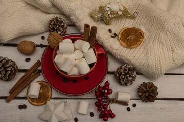 Christmas cocoa with marshmallows and cinnamon in a red cup, top view. coffee cup with homemade hot chocolate. Photo of a winter drink on a light background