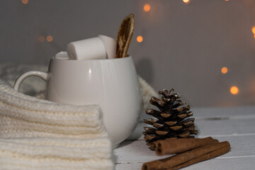 Christmas cocoa with marshmallows and cinnamon in a white cup. coffee cup with homemade hot chocolate. Photo of a winter drink on a light background