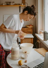 woman cooking in pyjama at the kitchen by morning