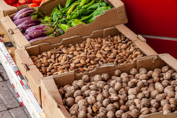 Selling nuts. Assortment of different salted and sweet organic nuts. Selling nuts in outdoor market.
