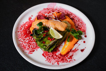 Salmon with grilled salad. restaurant serving seafood. Food cooking process.