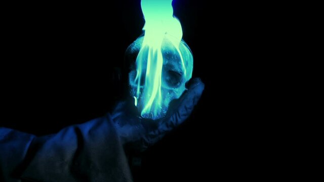 Wizard Holds Up Magic Burning Skull And Throws At Camera