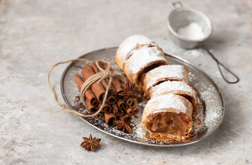 Traditional apple strudel with cinnamon and powdered sugar