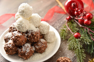 Pile of coconut and chocolate balls covered in coconut shavings