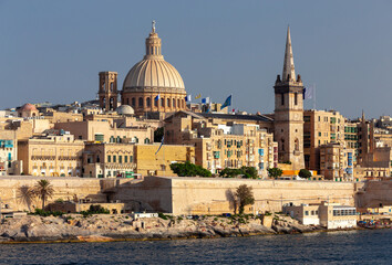 Fototapeta na wymiar Malta. The coastline along Valletta and the harbor at sunrise.