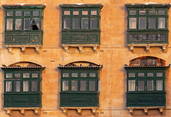 Fototapeta na wymiar Valletta. Traditional balconies on the facades of houses.