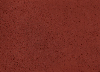 close up grainy red artificial stone texture background with blank space for design. cement with...