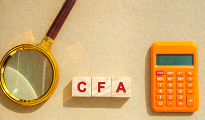 Wooden blocks with the words CFA - Chartered Financial Analyst. Postgraduate professional...