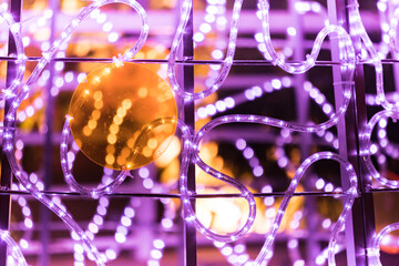 Violet led lights and yellow luminous balls to celebrate Christmas and other celebrations. Christmas and celebrations and festivities concept.
