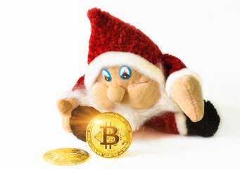 Bitcoin cryptocurrency coins and Christmas gnome toy isolated on white background. Cryptocurrency investment concept.