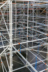 Metal construction scaffolding poles in a tall framework